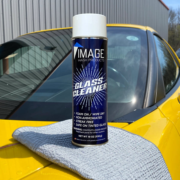 Aerosol can of Image Wash Products Glass Cleaner on hood of yellow Corvette