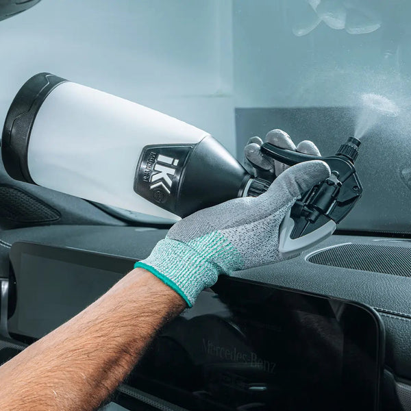 Trigger spraying upside down onto windshield glass in order to fit above a vehicles dashboard.