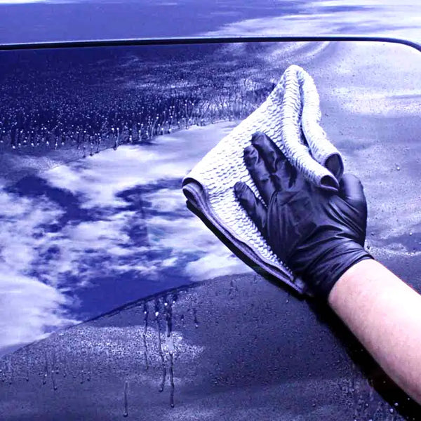 Applying glass cleaner to window.