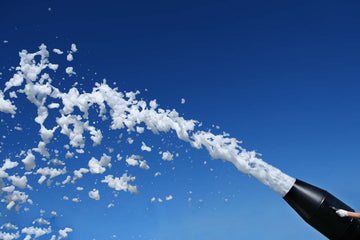 A man washing a car with foam