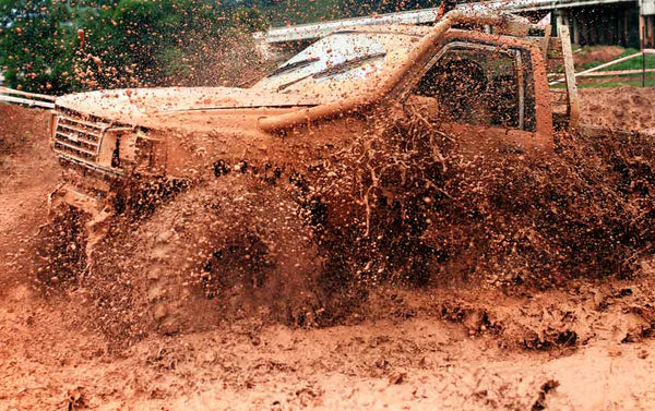 A truck splashing through the mud