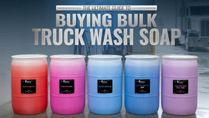Bulk truck wash soap in 55 gallon drums from Image Wash Products sitting on a truck wash bay floor with a white semi truck in the background.