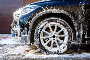 The front of a car covered in soap suds