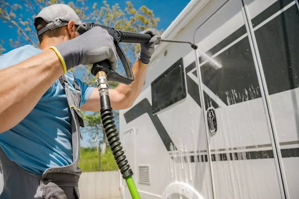 Man washes his RV with pressure washer