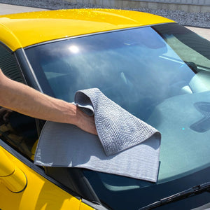 Cleaning Glass of a yellow corvette using Image Wash Products Glass cleaner and a premium ruffle pattern microfiber towel from Detail Factory.