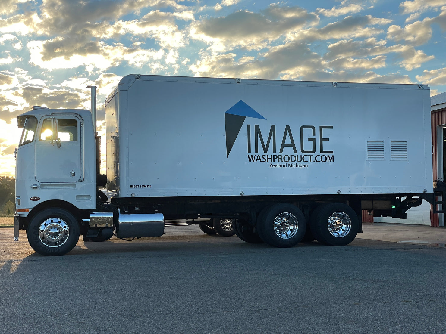 Image Wash Products clean semi truck parked in front of a beautiful sunset in Michigan.