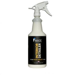 A white plastic spray bottle of Image Interior Detailer glossy non-greasy finish, featuring a black label with yellow and white text, on a solid white background.