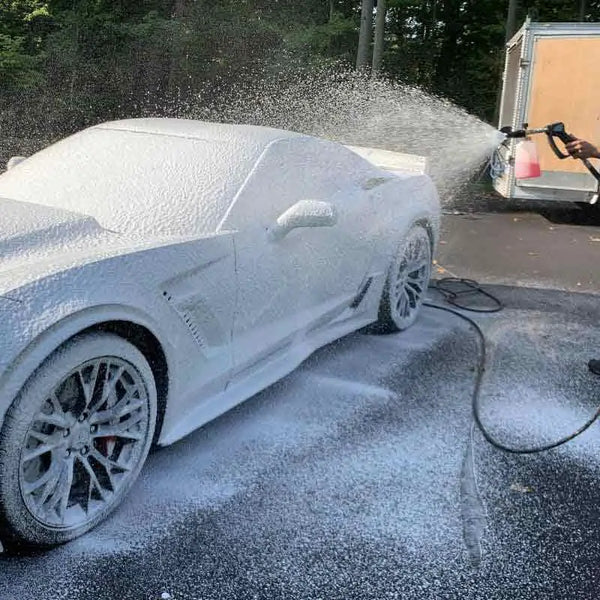 Image Wash Product employee foaming a car with a pressure washer foam cannon