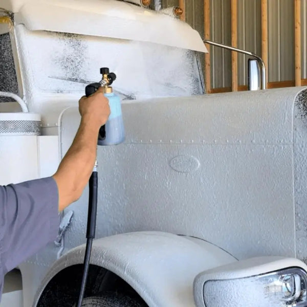 Image Wash Product employee foaming a big rig with a pressure washer foam cannon